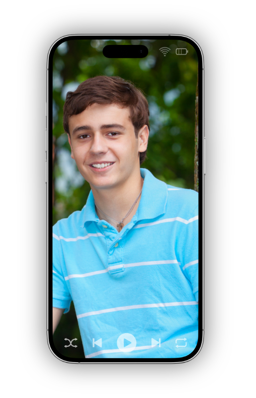A normal teen boy in an outdoor setting wearing a blue striped shirt